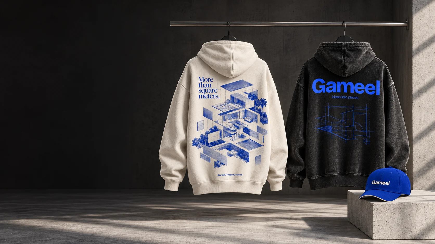 Cream architectural hoodie, black Gameel blueprint hoodie and cobalt cap